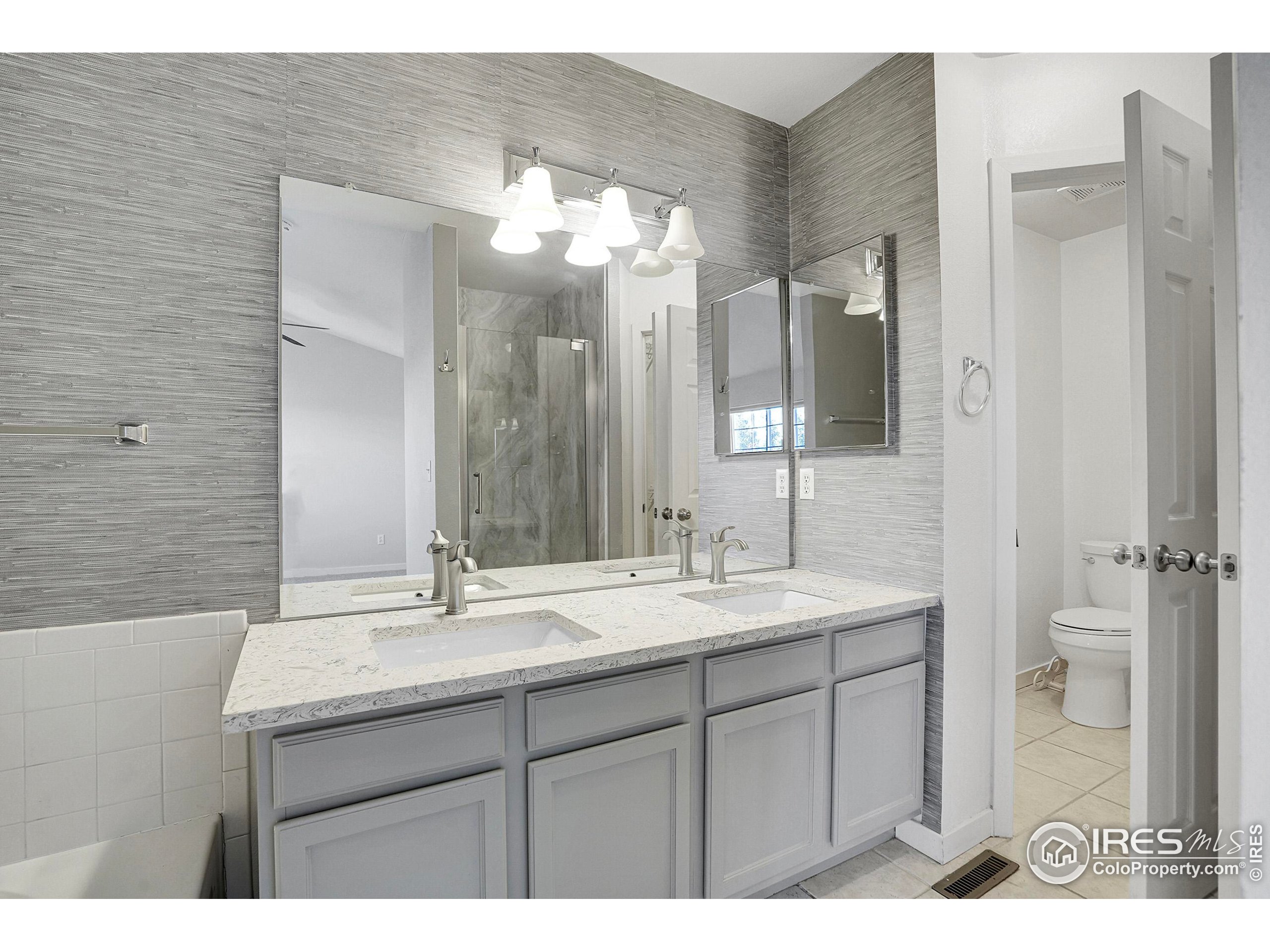 2408 Concord Circle Lafayette, CO 80026 - Photo 32 of 49 a bathroom with a sink and a mirror