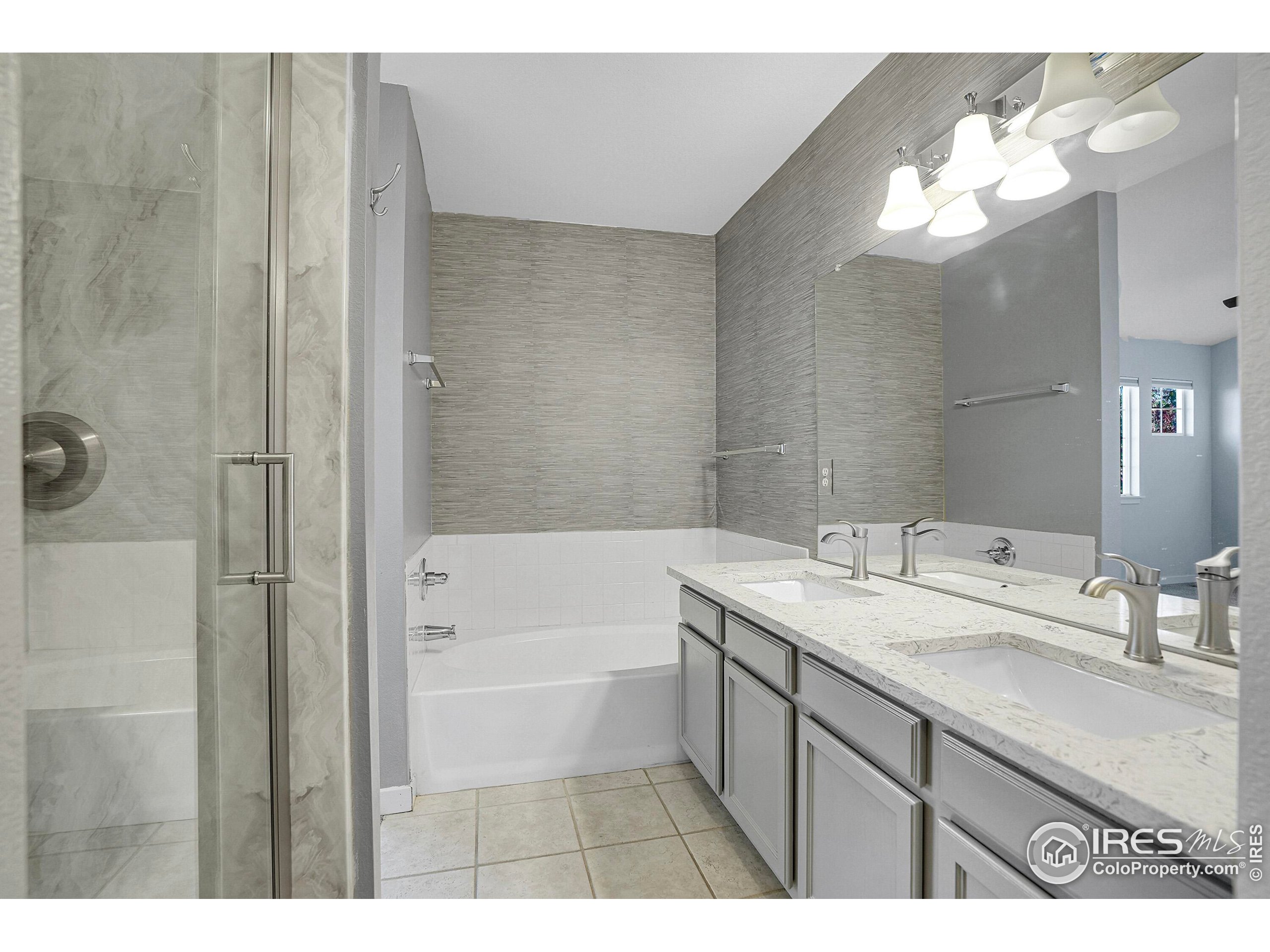 2408 Concord Circle Lafayette, CO 80026 - Photo 33 of 49 a bathroom with a sink a mirror and a bathtub