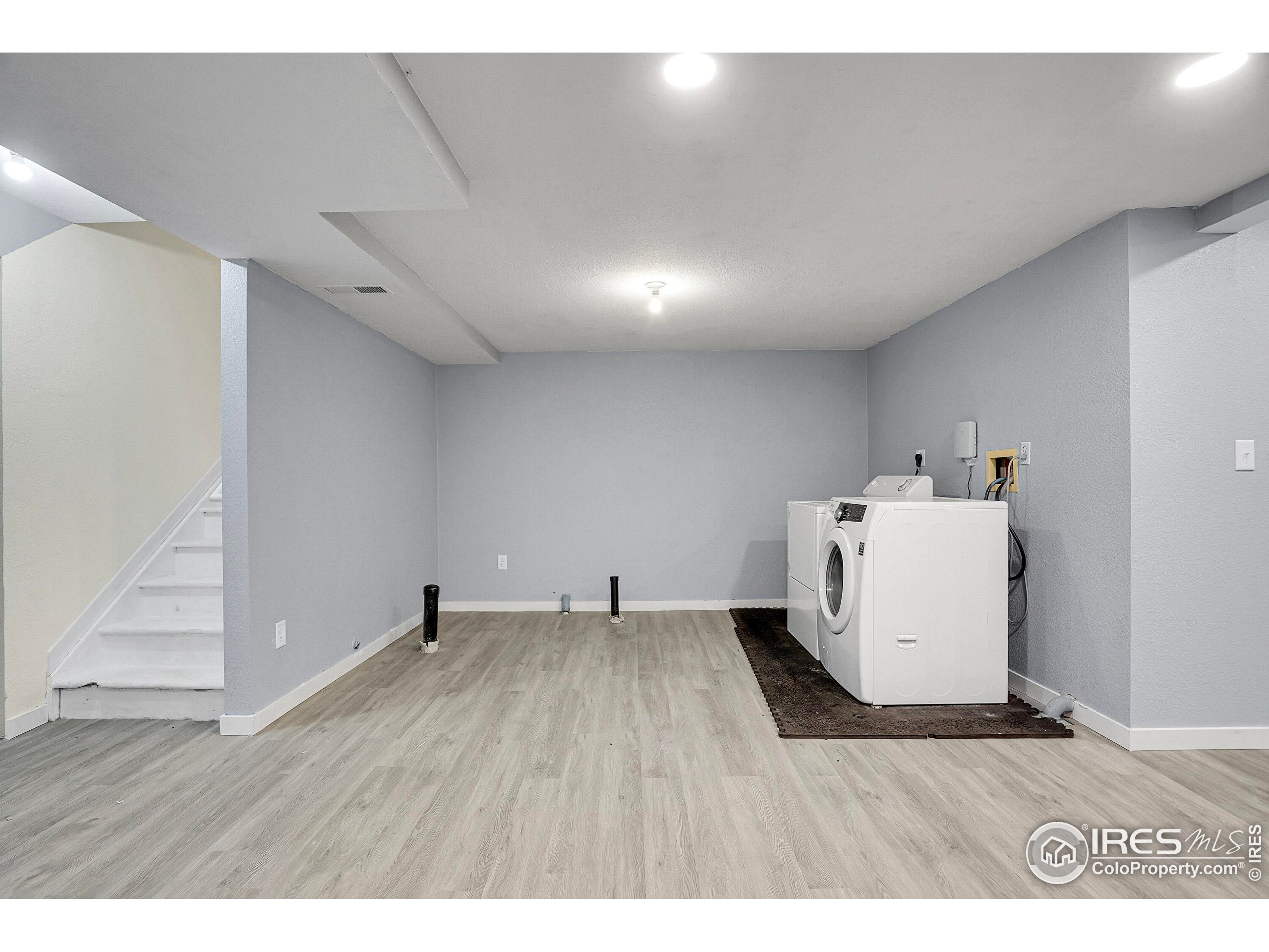 2408 Concord Circle Lafayette, CO 80026 - Photo 34 of 49 a room with wooden floor and white walls