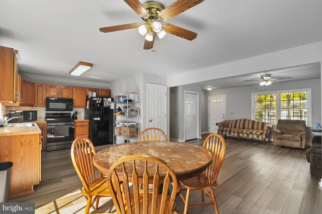 a dining room with furniture and wooden floor