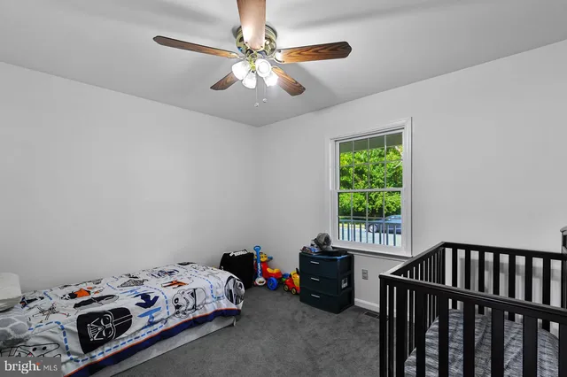 a bedroom with bed and a window