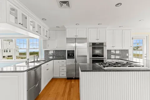 a kitchen with stainless steel appliances a refrigerator sink and cabinets