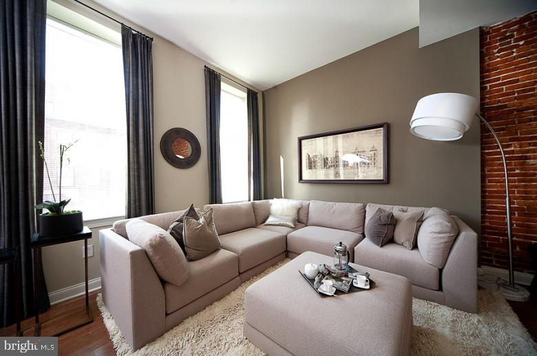 1201 North Charles Street, Unit 1BR Baltimore, MD 21201 - Photo 12 of 19 a living room with furniture and a window