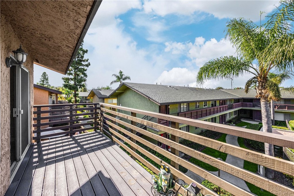 1410 West Lambert Road, Unit 202 La Habra, CA 90631 - Photo 13 of 30 a view of a balcony with wooden floor and fence