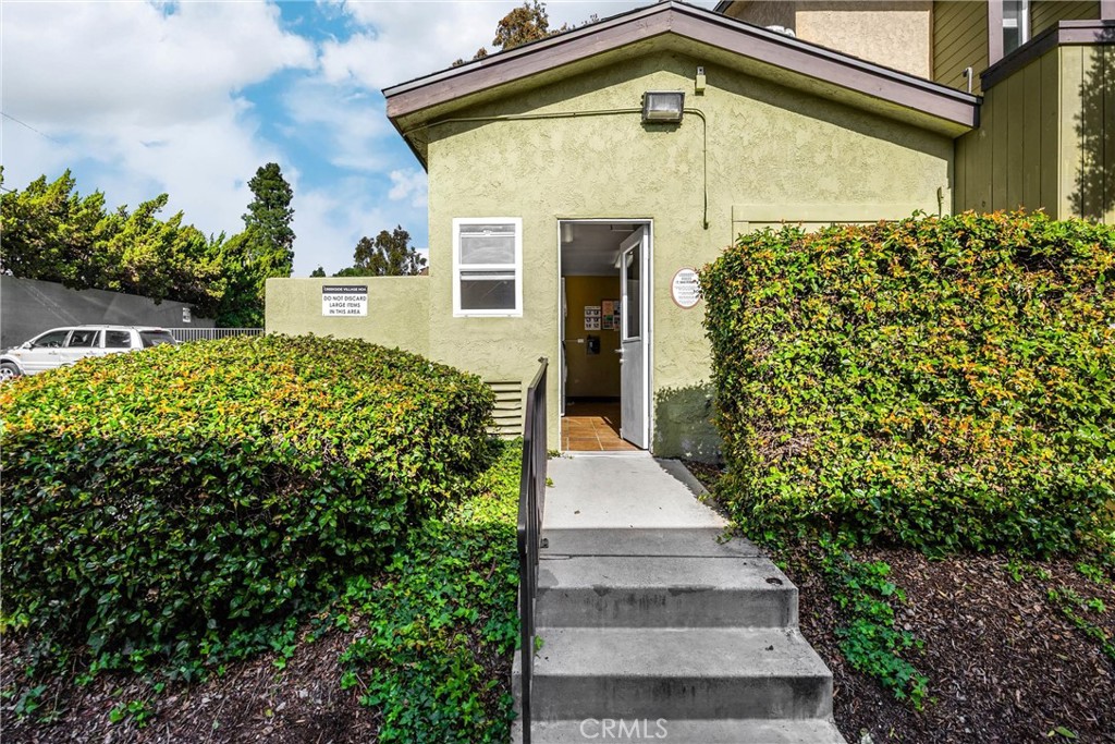 1410 West Lambert Road, Unit 202 La Habra, CA 90631 - Photo 23 of 30 a front view of a house with a yard