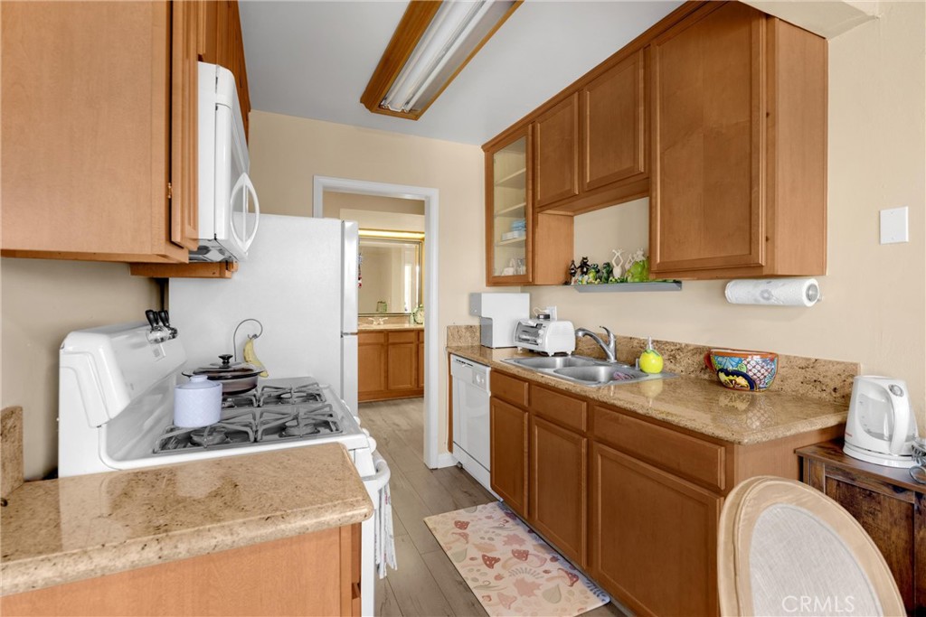 1410 West Lambert Road, Unit 202 La Habra, CA 90631 - Photo 9 of 30 a kitchen with a sink stove and cabinets