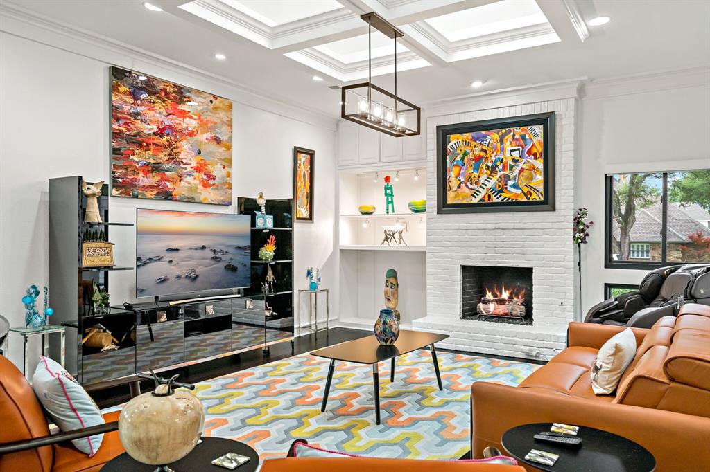 1324 Shetland Road Plano, TX 75093 - Photo 1 of 1 a living room with furniture a flat screen tv and a fireplace