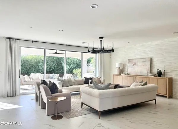 a living room with furniture and a large window