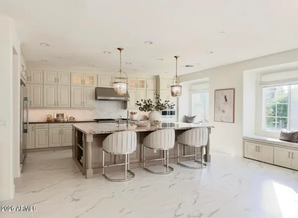 a kitchen with kitchen island a sink table and chairs