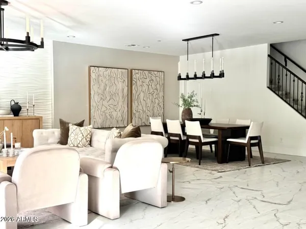 a living room with furniture a table and large window