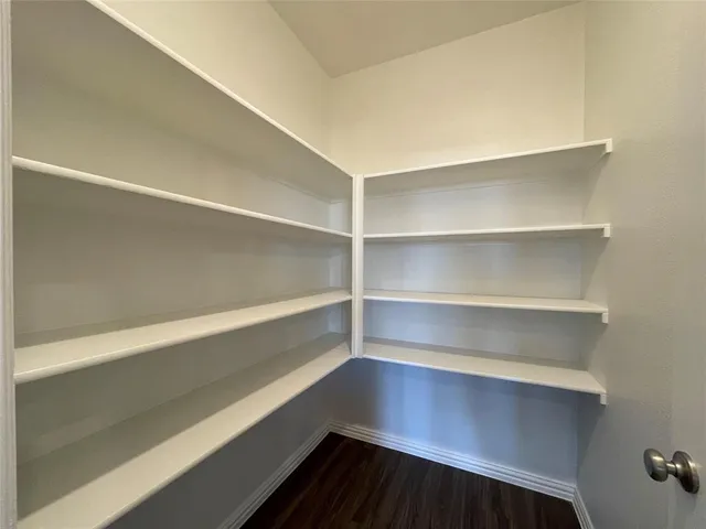 a kitchen with stainless steel appliances a sink a stove a microwave a center island and cabinets