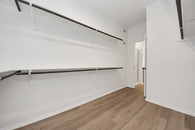 a view of a room with wooden floor