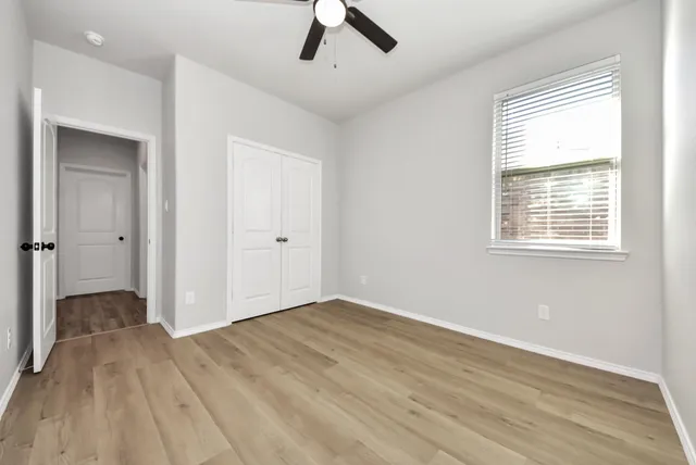wooden floor in an empty room with a window