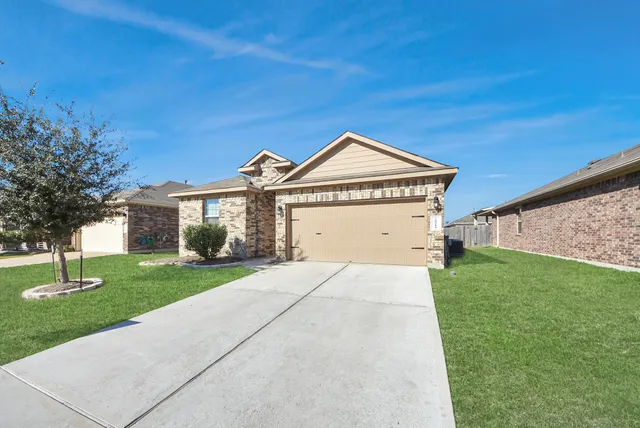 a view of a big house with a big yard and large trees