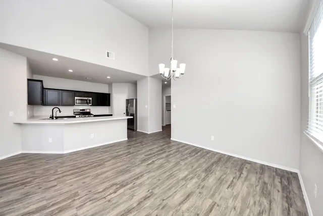 a view of kitchen with sink and refrigerator