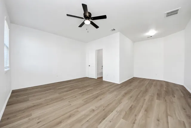 a view of a livingroom with a hardwood floor and a ceiling fan