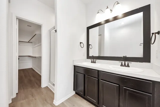 a bathroom with a double vanity sink and mirror