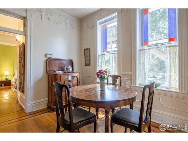 a view of a dining room with furniture and window