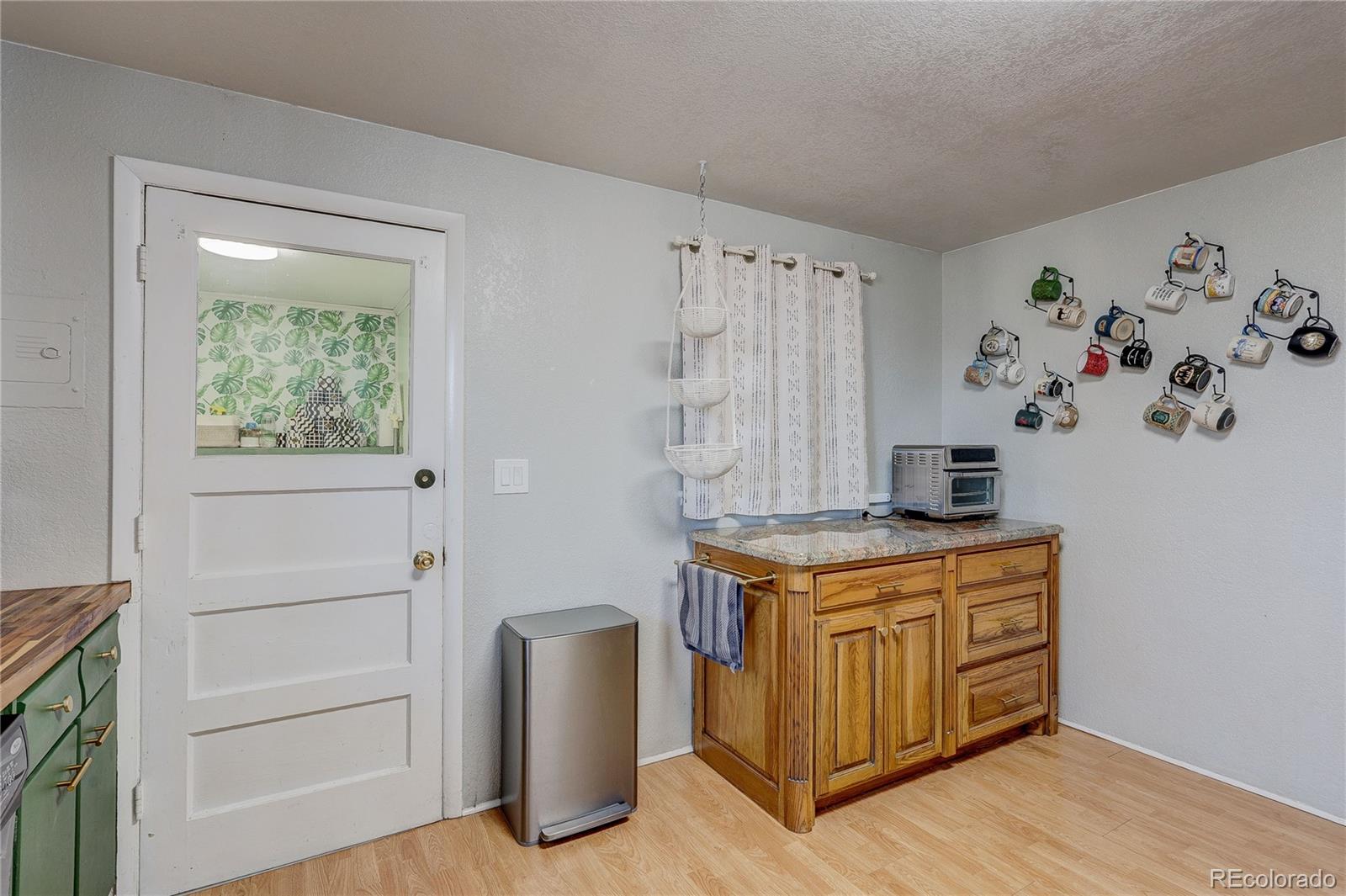 7950 Quebec Street Commerce City, CO 80022 - Photo 11 of 31 a view of cabinets with wooden floor and furniture