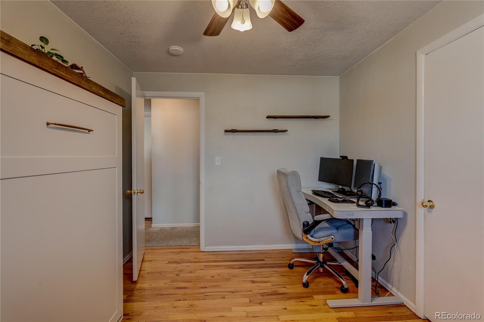 7950 Quebec Street Commerce City, CO 80022 - Photo 17 of 31 a view of workspace with wooden floor windows