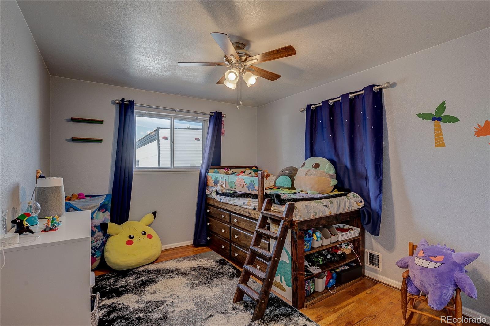 7950 Quebec Street Commerce City, CO 80022 - Photo 19 of 31 a bedroom with a bed and wooden floor