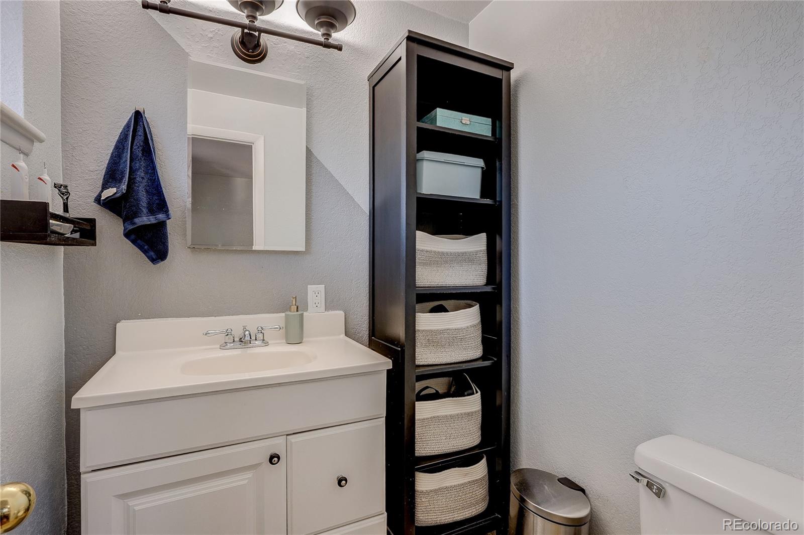 7950 Quebec Street Commerce City, CO 80022 - Photo 24 of 31 a bathroom with a sink toilet and vanity
