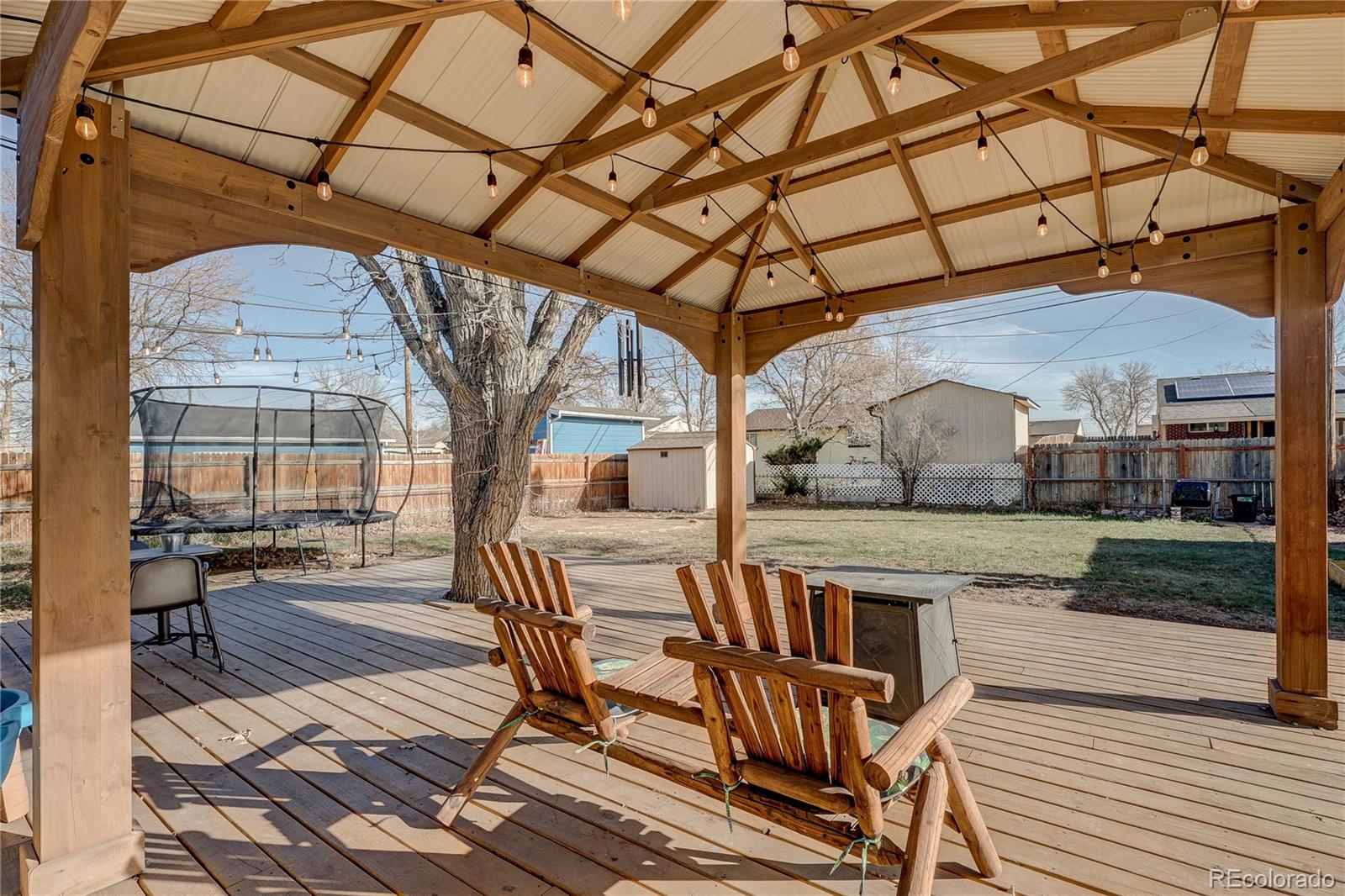 7950 Quebec Street Commerce City, CO 80022 - Photo 25 of 31 a view of a porch with furniture and a yard