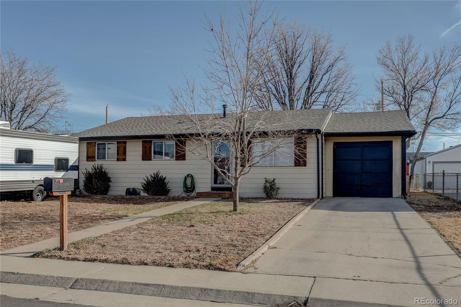 7950 Quebec Street Commerce City, CO 80022 - Photo 3 of 31 a front view of a house with garden