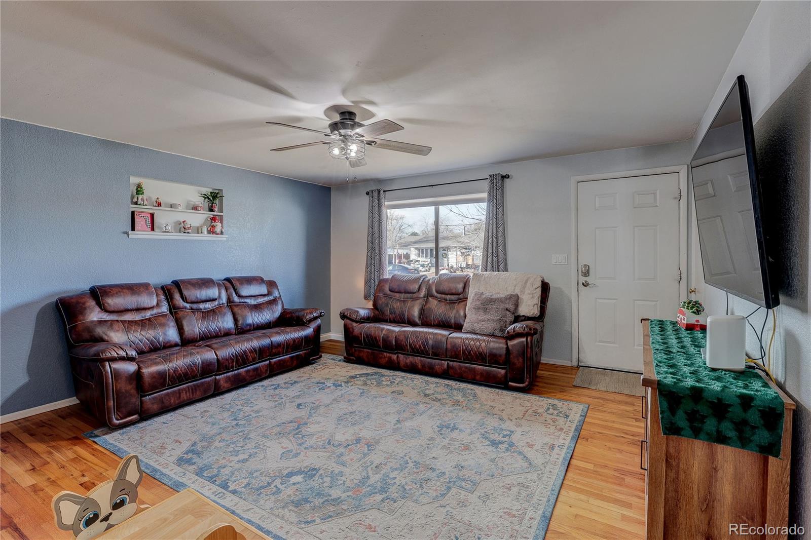 7950 Quebec Street Commerce City, CO 80022 - Photo 5 of 31 a living room with furniture ceiling fan and a rug