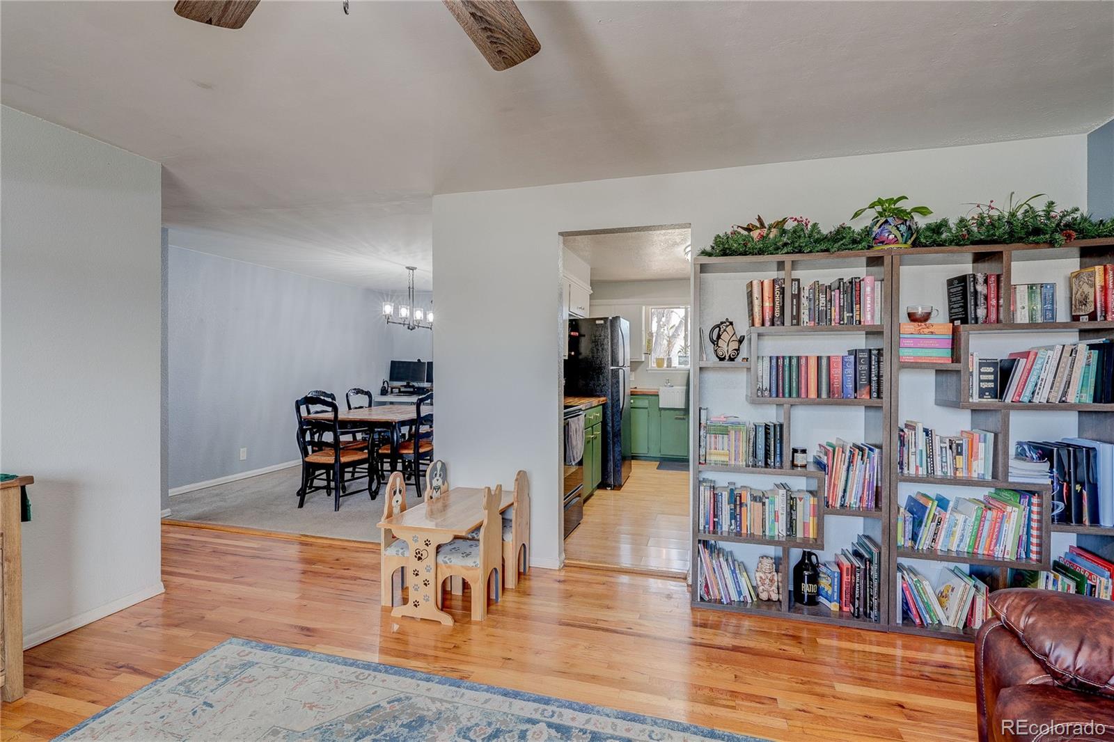7950 Quebec Street Commerce City, CO 80022 - Photo 7 of 31 a living room with lots of furniture and a book shelf