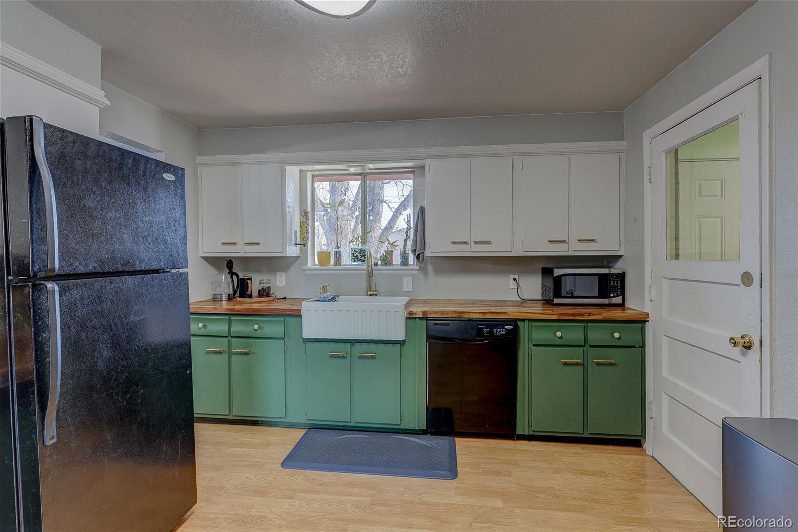 7950 Quebec Street Commerce City, CO 80022 - Photo 8 of 31 a kitchen with a refrigerator and a sink