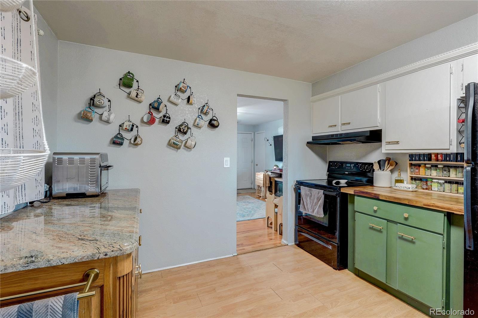 7950 Quebec Street Commerce City, CO 80022 - Photo 10 of 31 a kitchen with granite countertop a sink a stove and cabinets