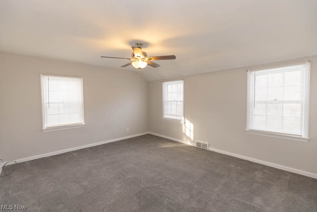 3890 Wallingford Road South Euclid, OH 44121 - Photo 15 of 19 Unfurnished room with dark carpet, lofted ceiling, and ceiling fan