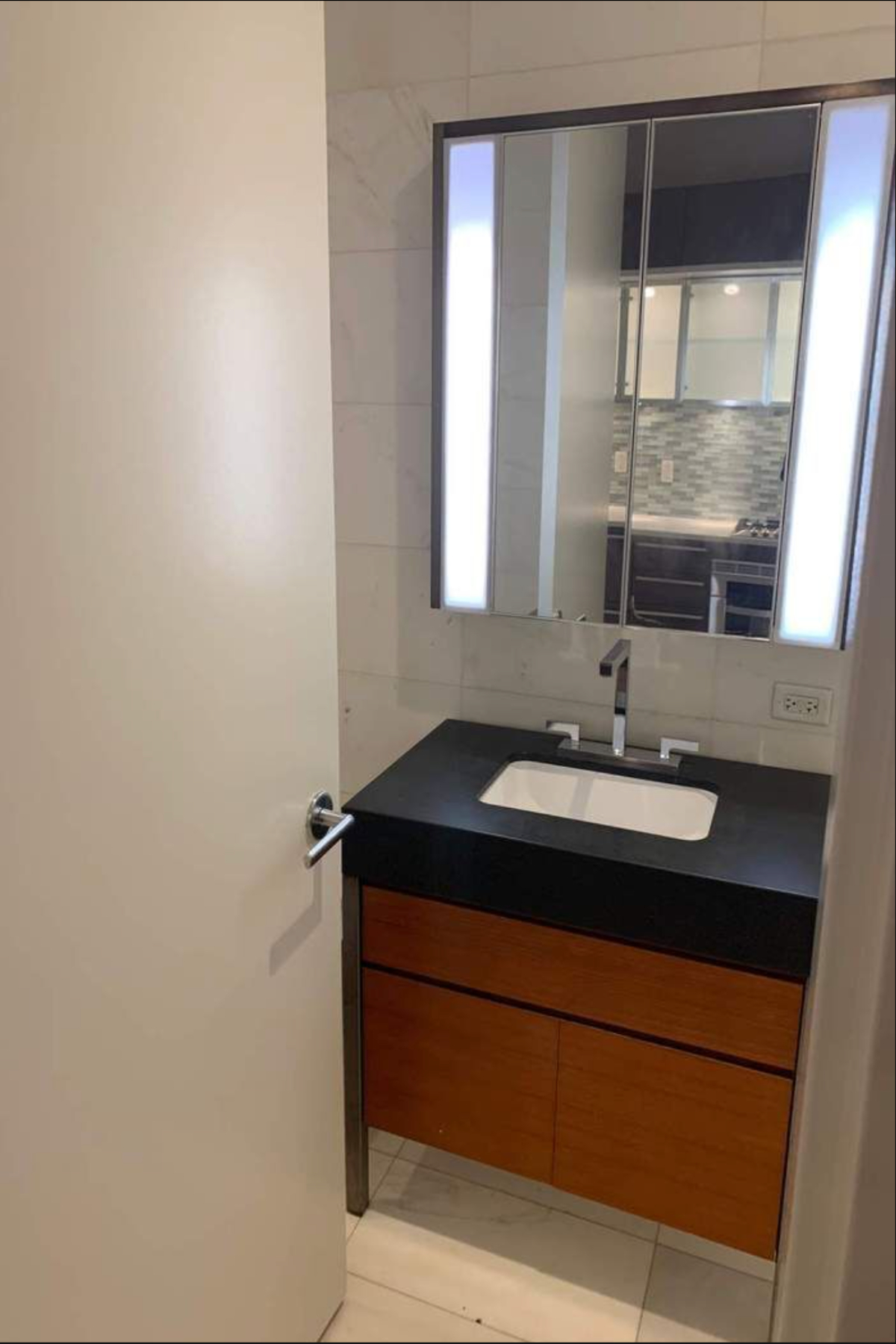 75 Wall Street, Unit 36J Manhattan, NY 10005 - Photo 4 of 7 a bathroom with a sink and a mirror