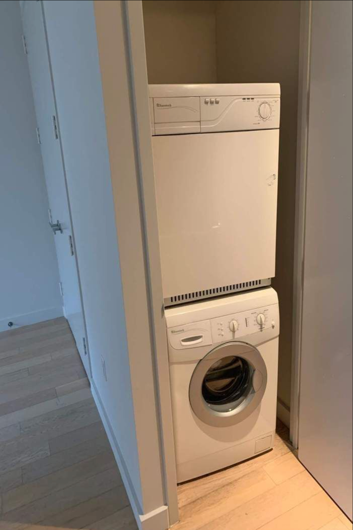 75 Wall Street, Unit 36J Manhattan, NY 10005 - Photo 6 of 7 a utility room with dryer and washer