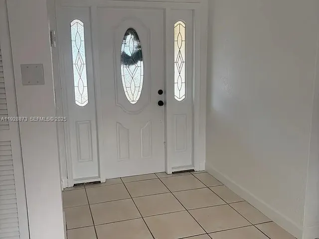 an empty room with mirror and a mirror