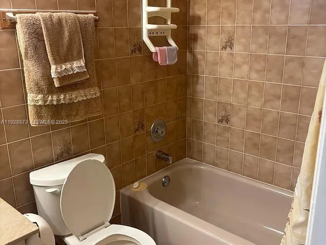 a bath tub sitting next to a toilet