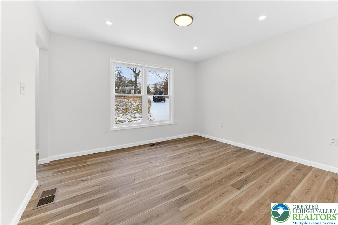 5693 Neola Road Stroudsburg, PA 18360 - Photo 13 of 30 an empty room with wooden floor and windows