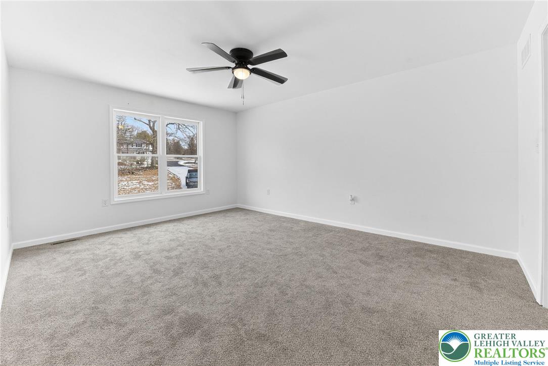 5693 Neola Road Stroudsburg, PA 18360 - Photo 16 of 30 an empty room with windows and fan view