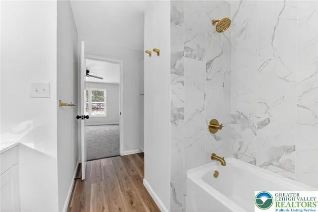 a bathroom with bathtub and shower