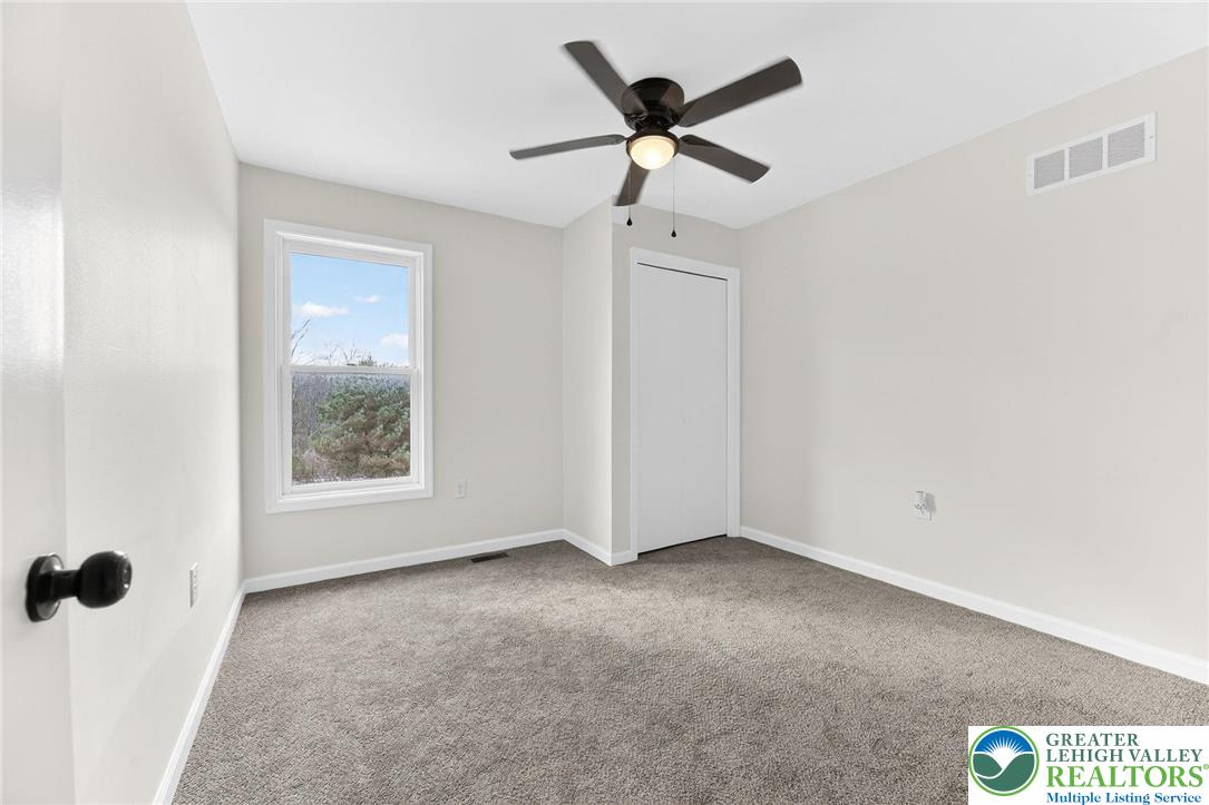 5693 Neola Road Stroudsburg, PA 18360 - Photo 21 of 30 a view of a ceiling fan and a window in a room