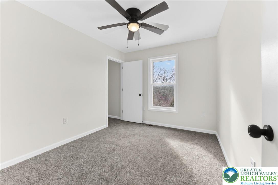 5693 Neola Road Stroudsburg, PA 18360 - Photo 22 of 30 a view of a livingroom with a ceiling fan and window