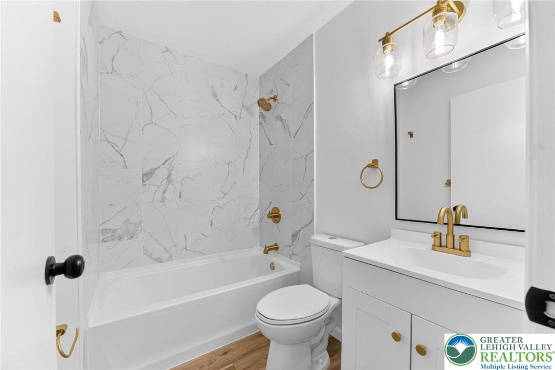 5693 Neola Road Stroudsburg, PA 18360 - Photo 24 of 30 a bathroom with a sink a toilet and a mirror