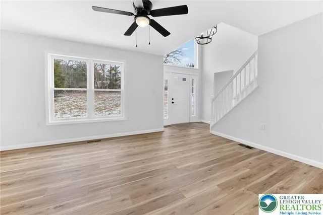 a view of an entryway with wooden floor