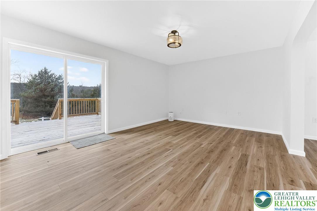 5693 Neola Road Stroudsburg, PA 18360 - Photo 8 of 30 a view of a room with wooden floor and glass door