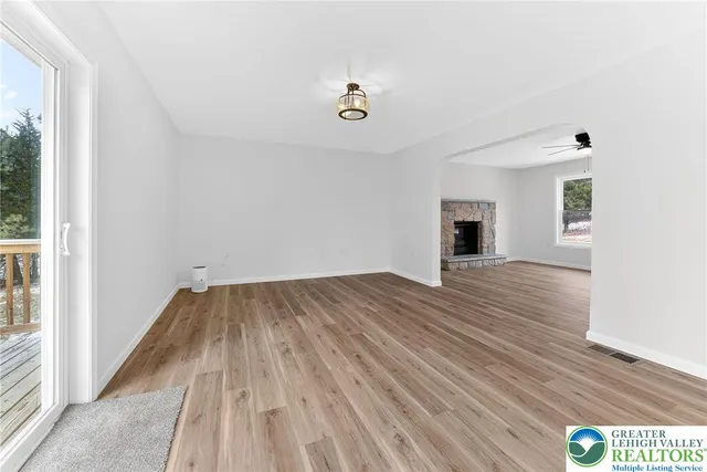 a view of empty room with wooden floor