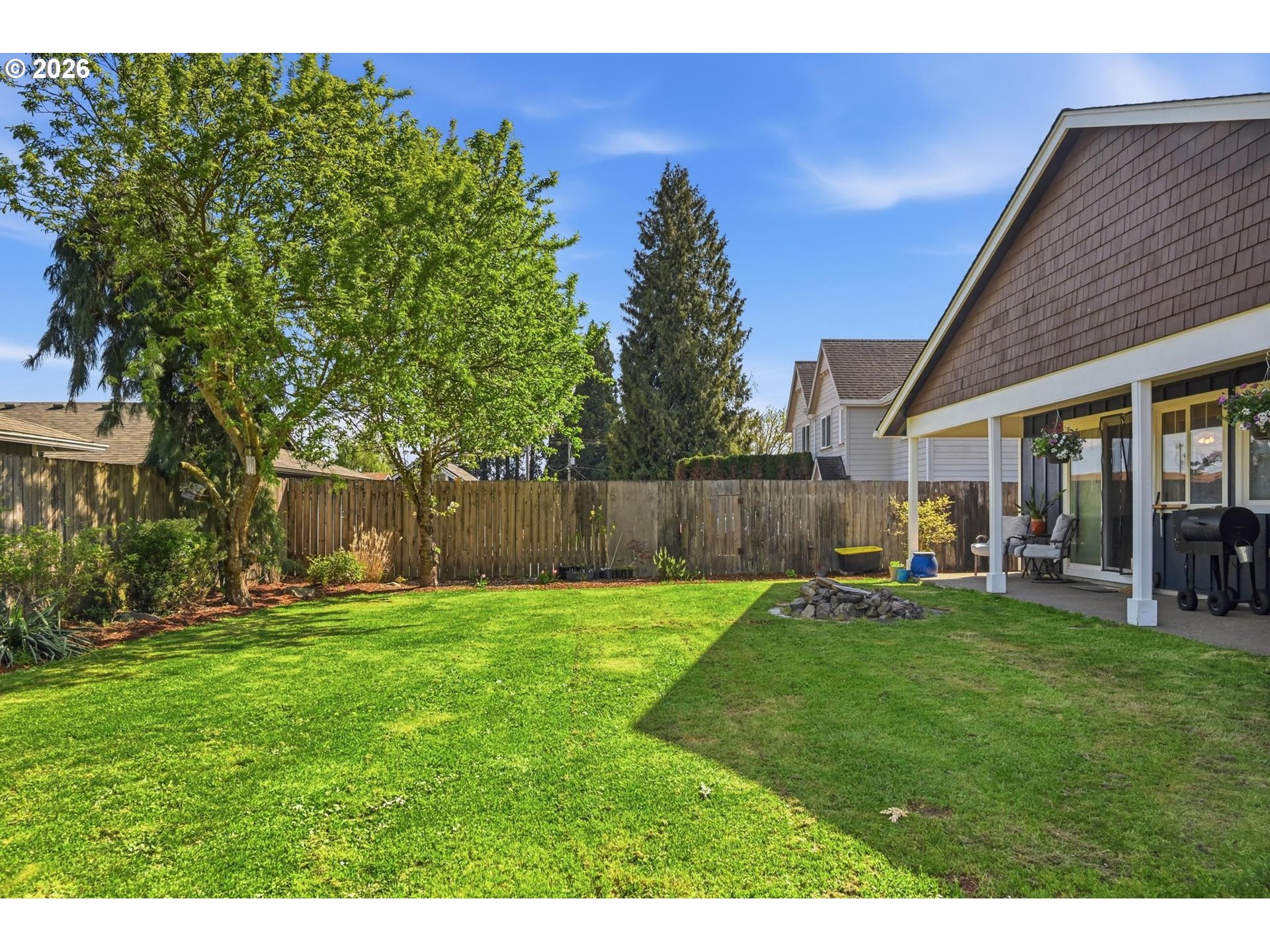 624 North Pershing Street Mount Angel, OR 97362 - Photo 2 of 47 a view of a backyard with table and chairs and wooden fence