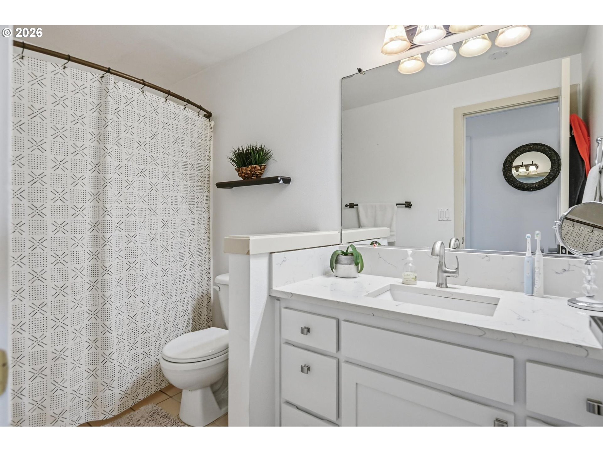 624 North Pershing Street Mount Angel, OR 97362 - Photo 30 of 47 a bathroom with a sink vanity granite toilet and a mirror