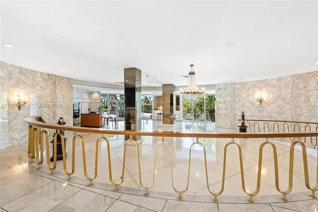 a bedroom with a bed a flat screen tv and dresser next to a window