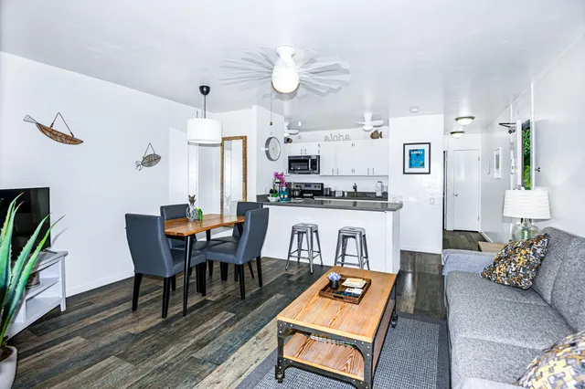 a living room with kitchen island furniture and a chandelier